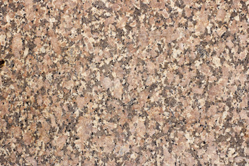 The texture of a spotted granite slab of orange color