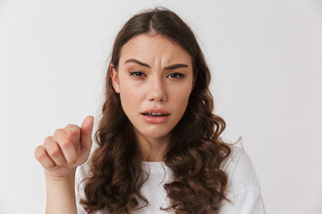 Portrait of an angry young casual brunette woman