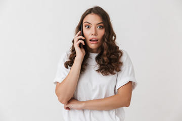 Fototapeta premium Portrait of a shocked young casual brunette woman