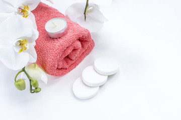 Spa accessories: soap, candle, towel, salt and orchid on isolated white background. Spa salon and theraphy.