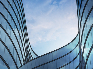 Perspective of high rise building and dark steel window system with clouds reflected on the...