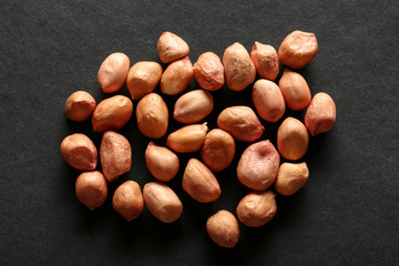 Tasty peanuts on dark background