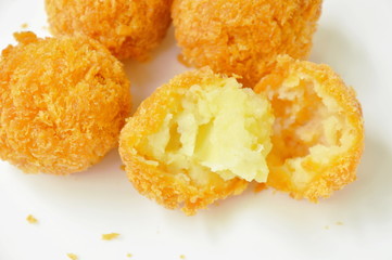fried cheese ball cutting on white plate