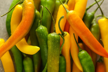 Fresh chili peppers on table, closeup