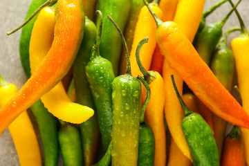 Fresh chili peppers on table, closeup