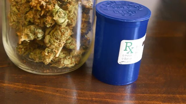 SLIDER SHOT Marijuana in glass jar and Rx for recreational or prescription medicinal weed smoking.