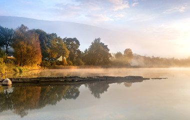 Fototapeta na wymiar Mist burning off Loch Ard on an Autumn morning