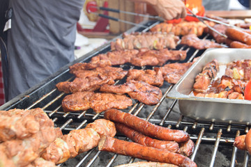 sausage steaks skewers grilled at festivity with peppers