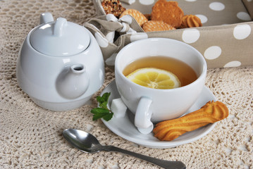  breakfast in white ceramics with light tea with cookies