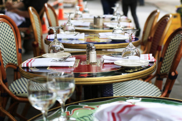 Outdoor cafe table with glasses and napkins