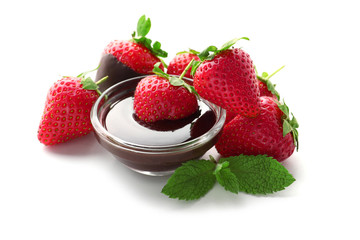 Fresh ripe strawberries with melted chocolate on white background