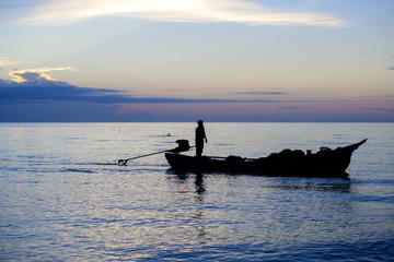 Fishermen out fishing at sunrise in the sea