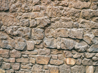 The texture of a stone fence made of granite. Background