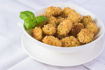 Baked crispy potato gnocchi with bread crumbs.