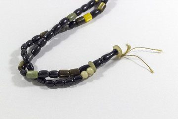 Close-up detail shot of handmade black and green stone islamic prayer beads
