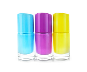 Bottles of colorful nail polishes on white background