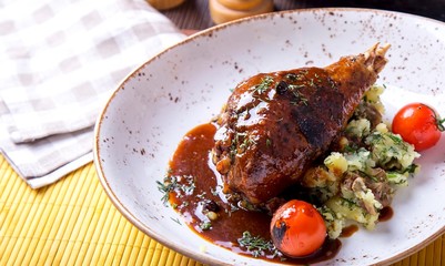 Delicious  turkey leg in sauce with potato and  cherry tomatoes. Copyspace