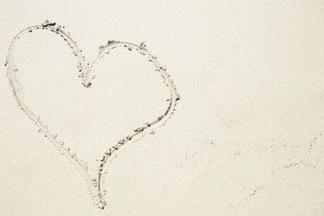 Heart sign on a sandy beach. Copyspace