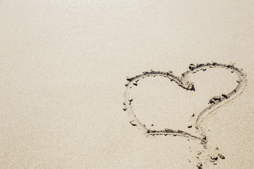 Heart sign on a sandy beach. Summer vocation. Copyspace