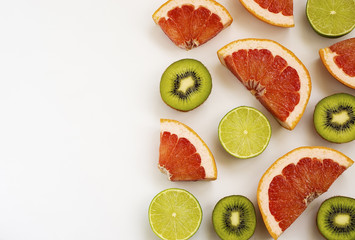 Fototapeta na wymiar cut ripe lime kiwi fruit and grapefruit