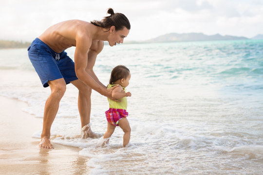 Happy Father And Daughter Playing Together On The Beach Outside.