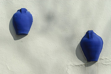 indigo colored decorative objects on a wall in Campo de Criptana, Spain.