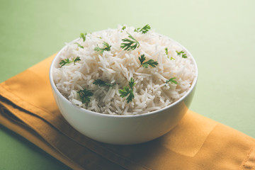 Coriander or cilantro Basmati Rice, served in a ceramic or terracotta bowl. It's a popular Indian OR Chinese recipe. Selective focus