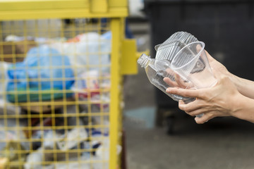 Disposable plastic is sorted into a garbage container. Concept pollution of the environment. 