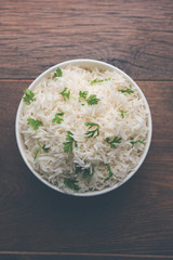 Coriander or cilantro Basmati Rice, served in a ceramic or terracotta bowl. It's a popular Indian OR Chinese recipe. Selective focus