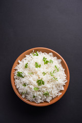Coriander or cilantro Basmati Rice, served in a ceramic or terracotta bowl. It's a popular Indian OR Chinese recipe. Selective focus