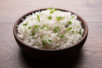 Coriander or cilantro Basmati Rice, served in a ceramic or terracotta bowl. It's a popular Indian OR Chinese recipe. Selective focus