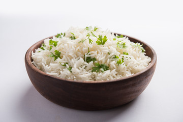 Coriander or cilantro Basmati Rice, served in a ceramic or terracotta bowl. It's a popular Indian OR Chinese recipe. Selective focus