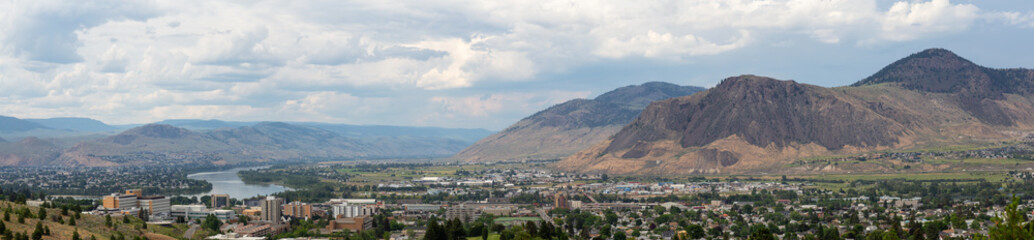 Aerial panoramic view of Kamloops City during a cloudy summer day. Located in Interior BC, Canada.