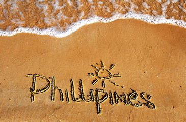 Phillipines word on sand beach background
