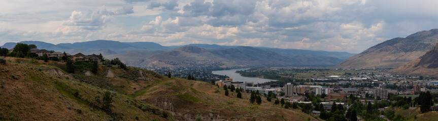 Fototapeta na wymiar Aerial panoramic view of Kamloops City during a cloudy summer day. Located in Interior BC, Canada.
