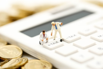 Miniature people : worker and box with  coins  and Calculator of tax,shipping, rent container, business concept.