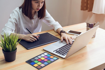 woman using laptop on table in office room, for graphics display montage.