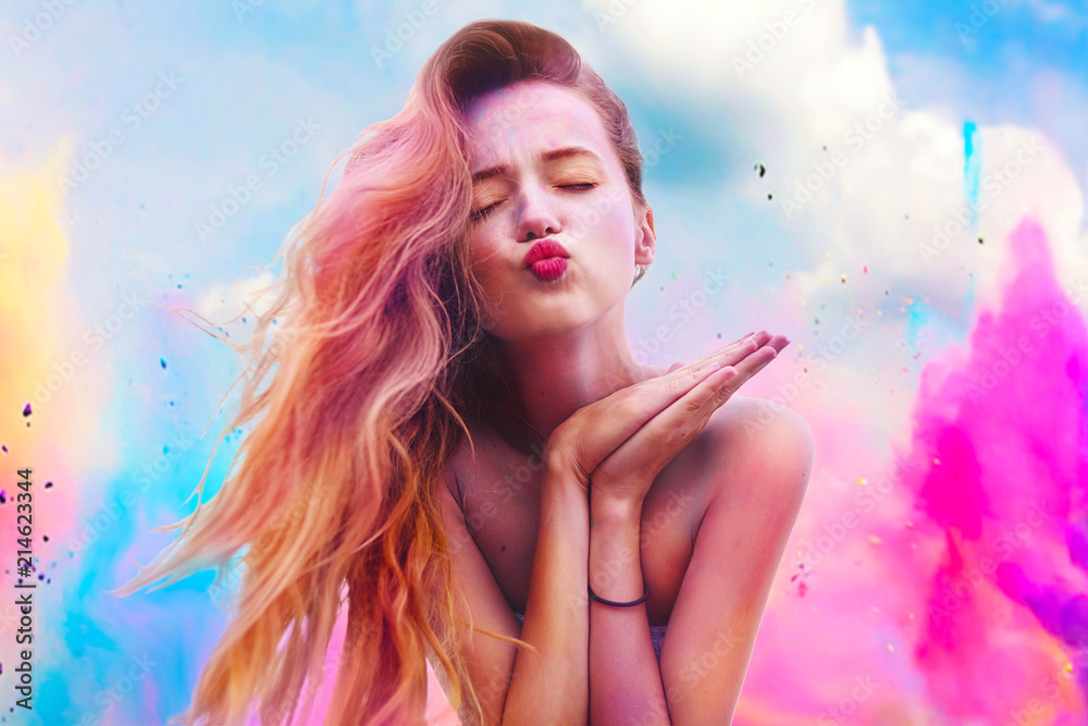 Wall mural holi festival of colours. portrait of happy young pretty girl on holi color festival. girl kiss with