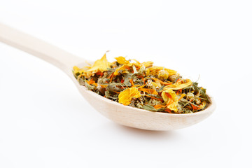 Medicinal herbal tea leafs in a wooden spoon on white background. Health and beauty concept.