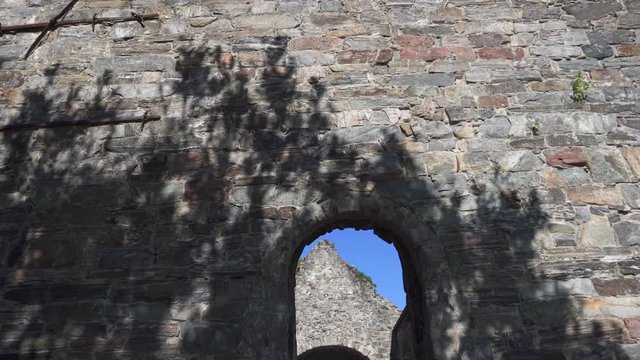 Walking inside medieval ruins of church in sunny weather with blue sky, panning down in 4k.
Location Nes Norway