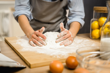 Preparing a great cherry pie. Woman making dough.