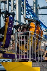 Happy young girl having fun on boardwalk amusement ride
