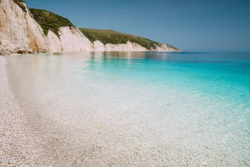 Rolgordijnen Fteri beach in Kefalonia Island, Greece. One of the most beautiful untouched pebble beach with pure azure emerald sea water surrounded by high white rocky cliffs of Kefalonia © Igor Tichonow