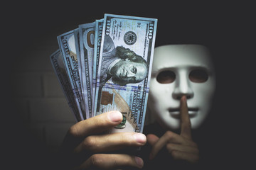 Bribery people with dollar bills in hand and quiet gesture
