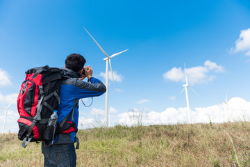 man photographer taking photo of the wind turbines generating electricity Travel Lifestyle...