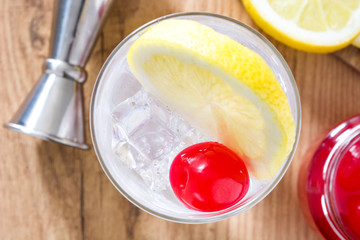 Classic Tom Collins cocktail on wooden table. Top view