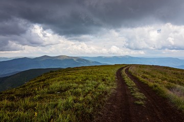 Fototapeta na wymiar Dirt road on Ukrainian mountains