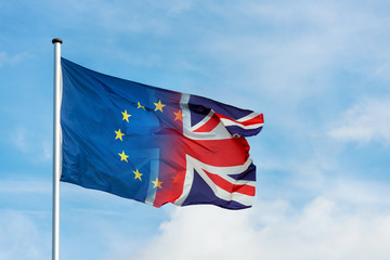 European and british flag merging with dark clouds and lightning bolt as sign for Brexit