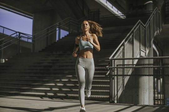 Young Woman Running In The Urban Environment