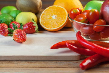 Healthy concept with mixed fruits and vegetables on wooden background